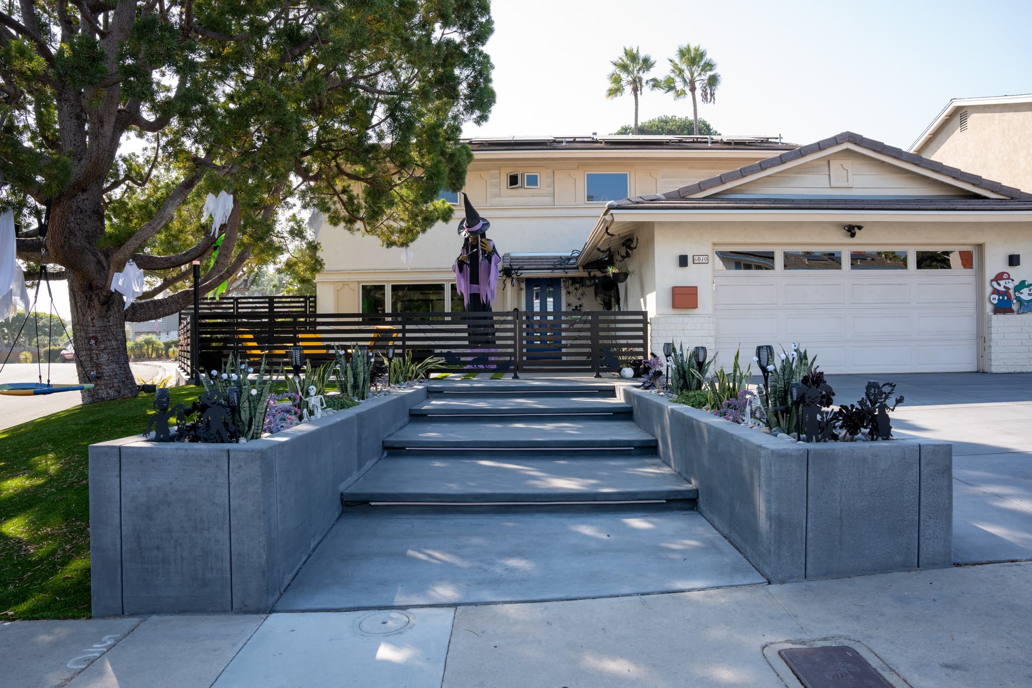 Patio with horizontal slat fence, fire pit, and outdoor kitchen setup