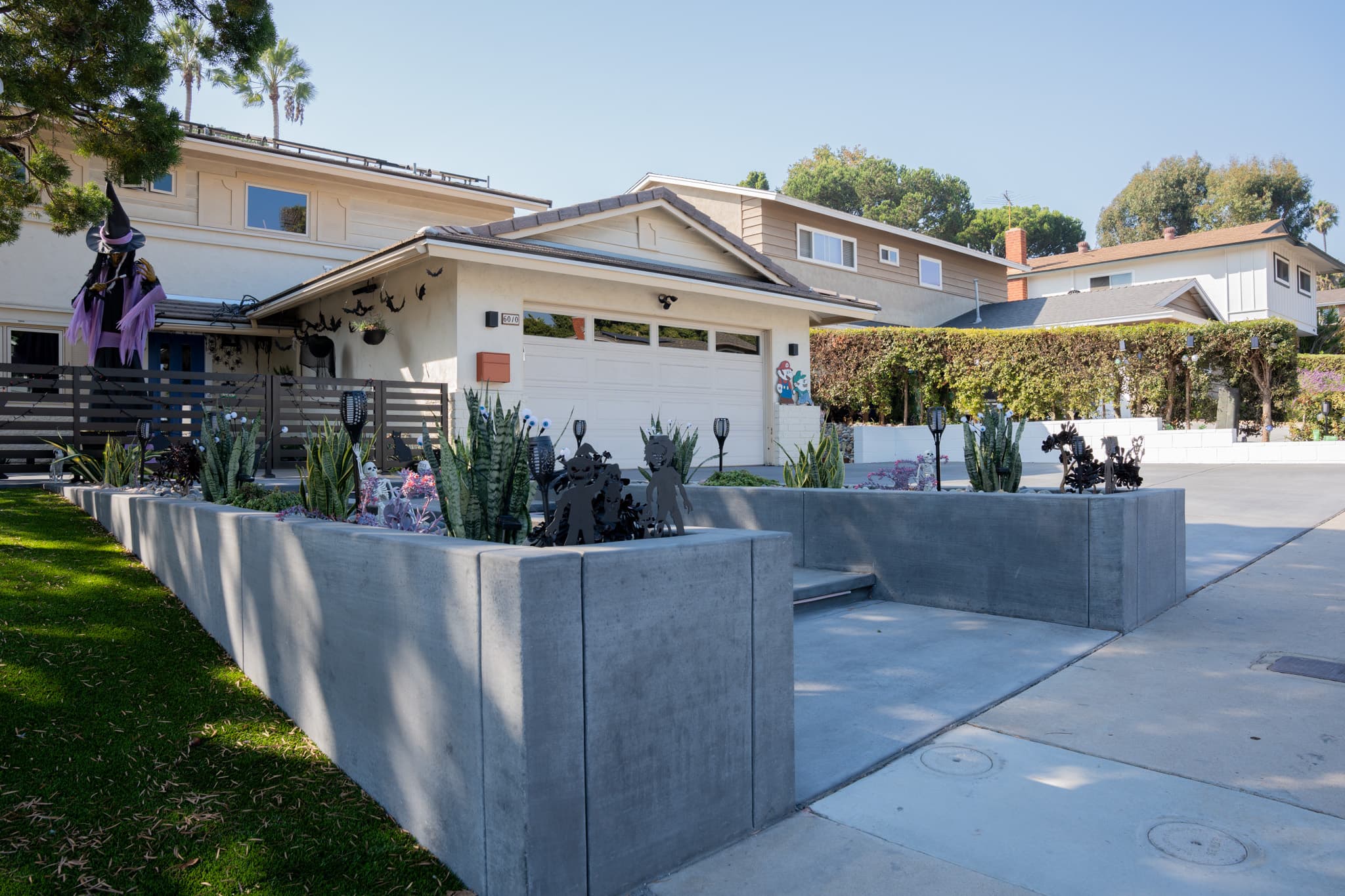 Luxury outdoor remodel with custom hardscaping and privacy screen.