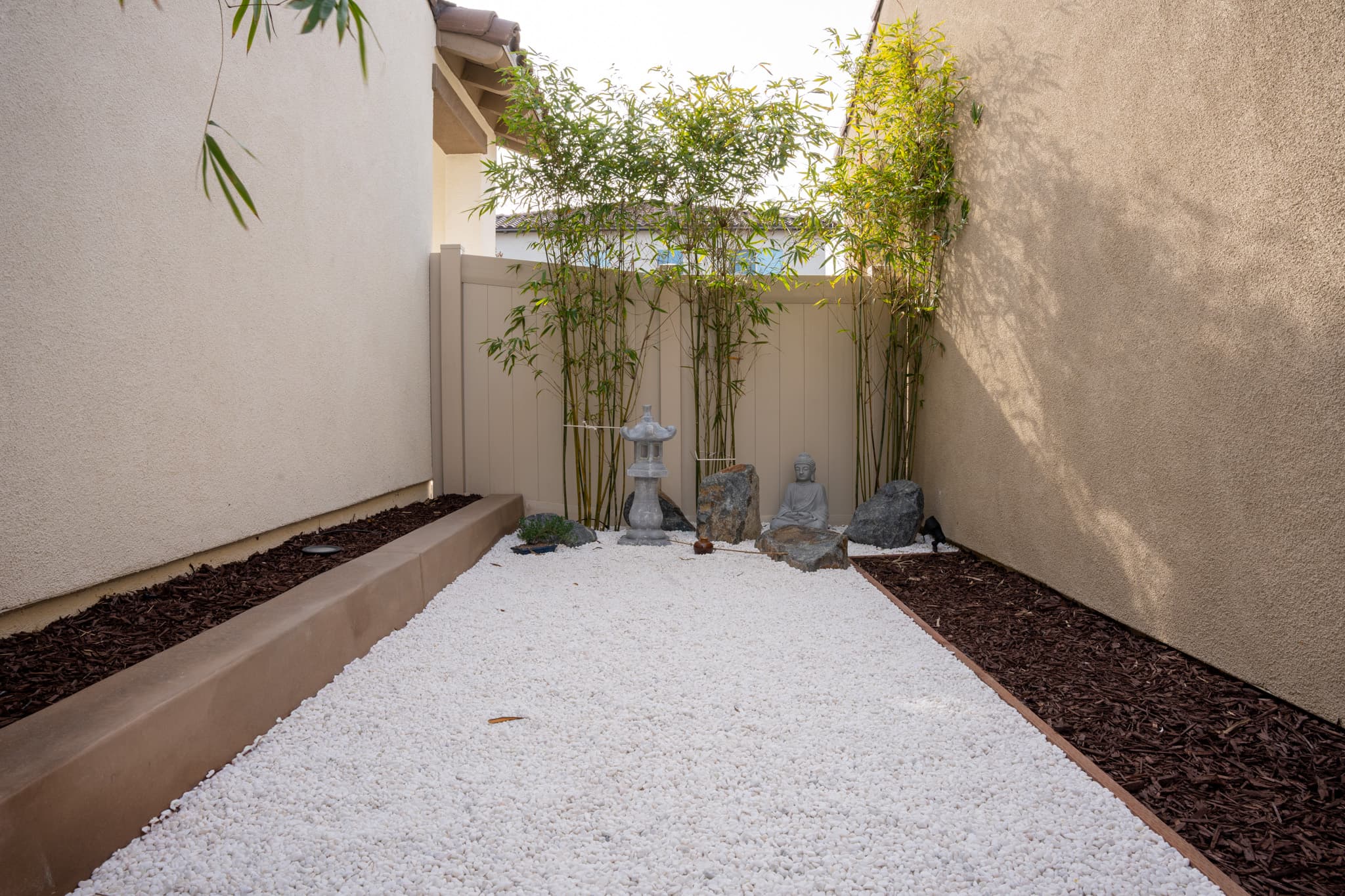 Zen garden with bamboo, decorative stones, and a peaceful meditation corner.